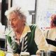 Pub patrons are surprised as Rod Stewart pulls drinks from behind the bar.